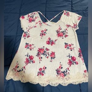 Rewind floral top size L crosses in the back